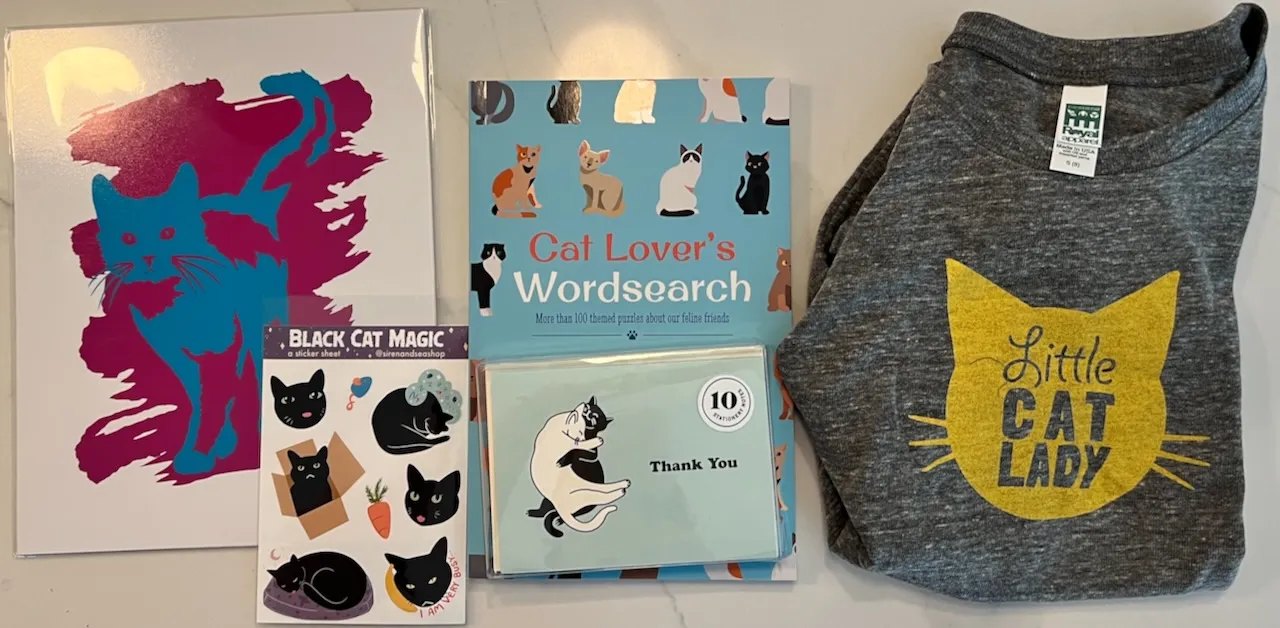 Various cats art, books, and clothing.