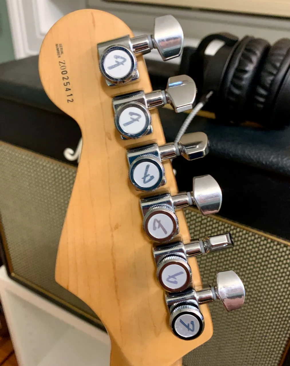 Picture of the back of the headstock of the guitar with locking tuners