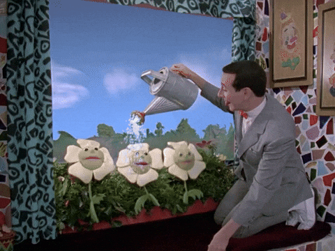 Pee Wee Herman watering anthropomorphic flowers